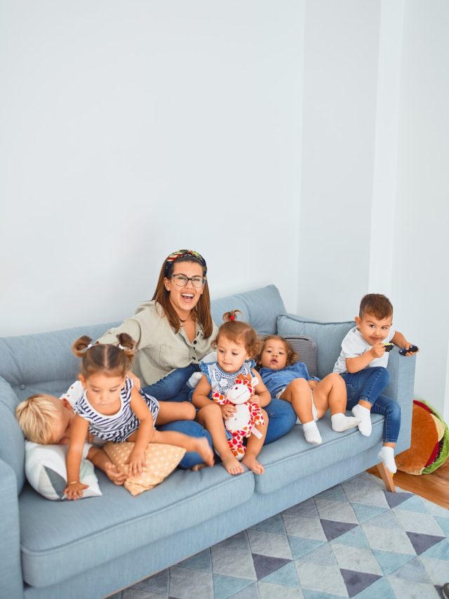 3 women sitting on gray couch